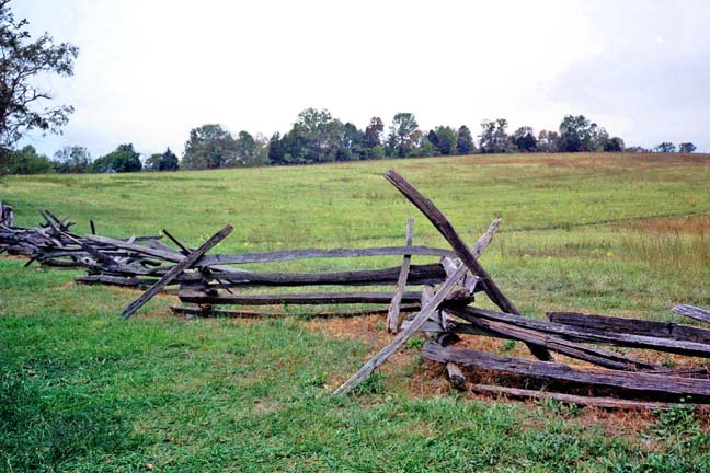 fence and hilly field